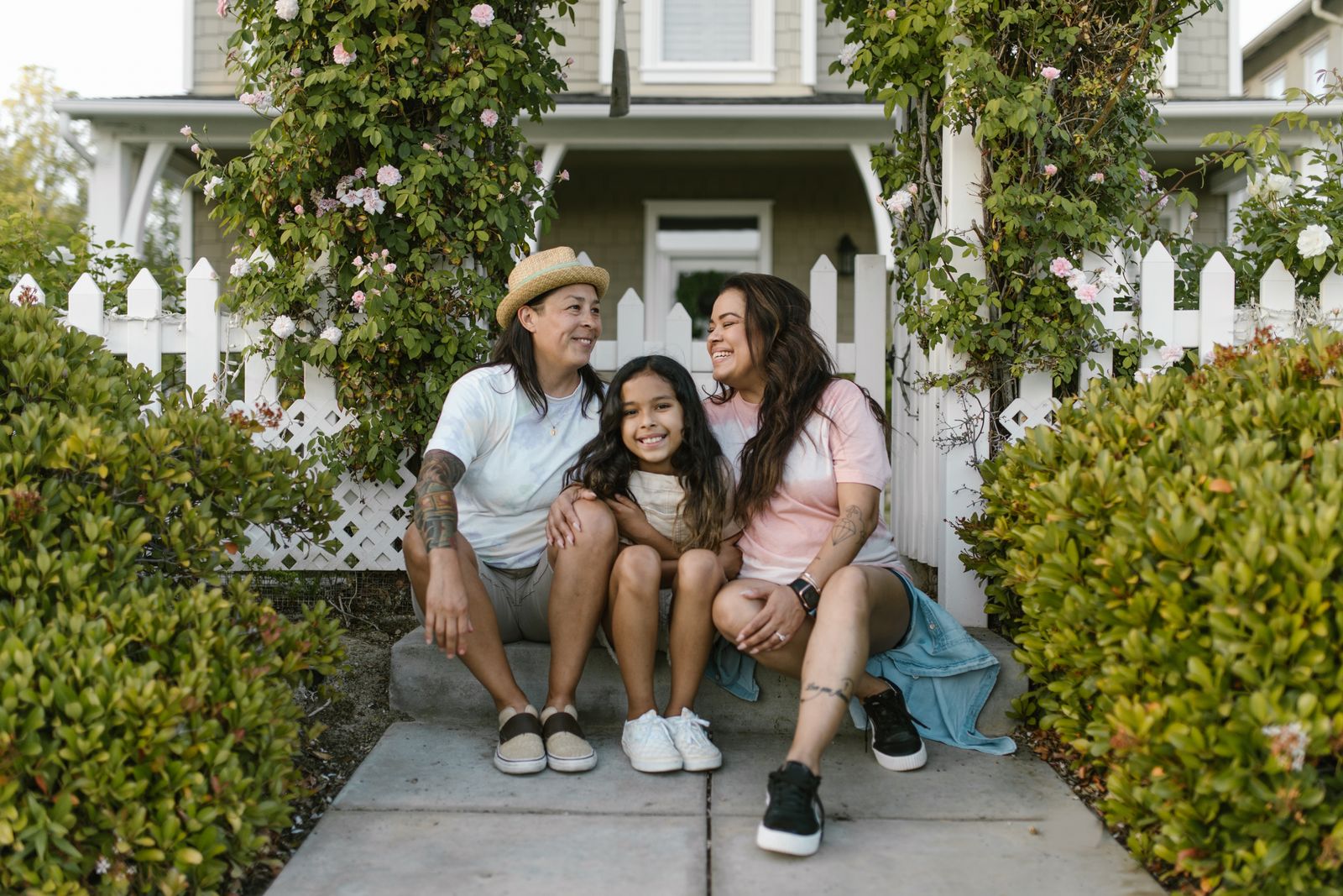 A family sitting together outside their home